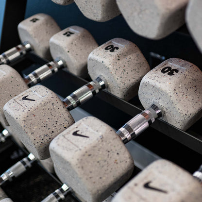 Set of Nike Grind dumbbells on a Nike rack